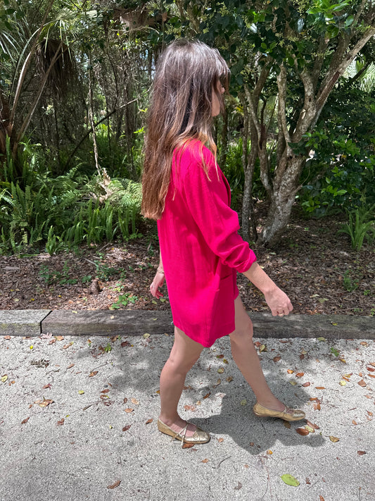 Girl standing in park in oversized denim shorts wearing bright pink vintage blazer and american vintage tank top. 