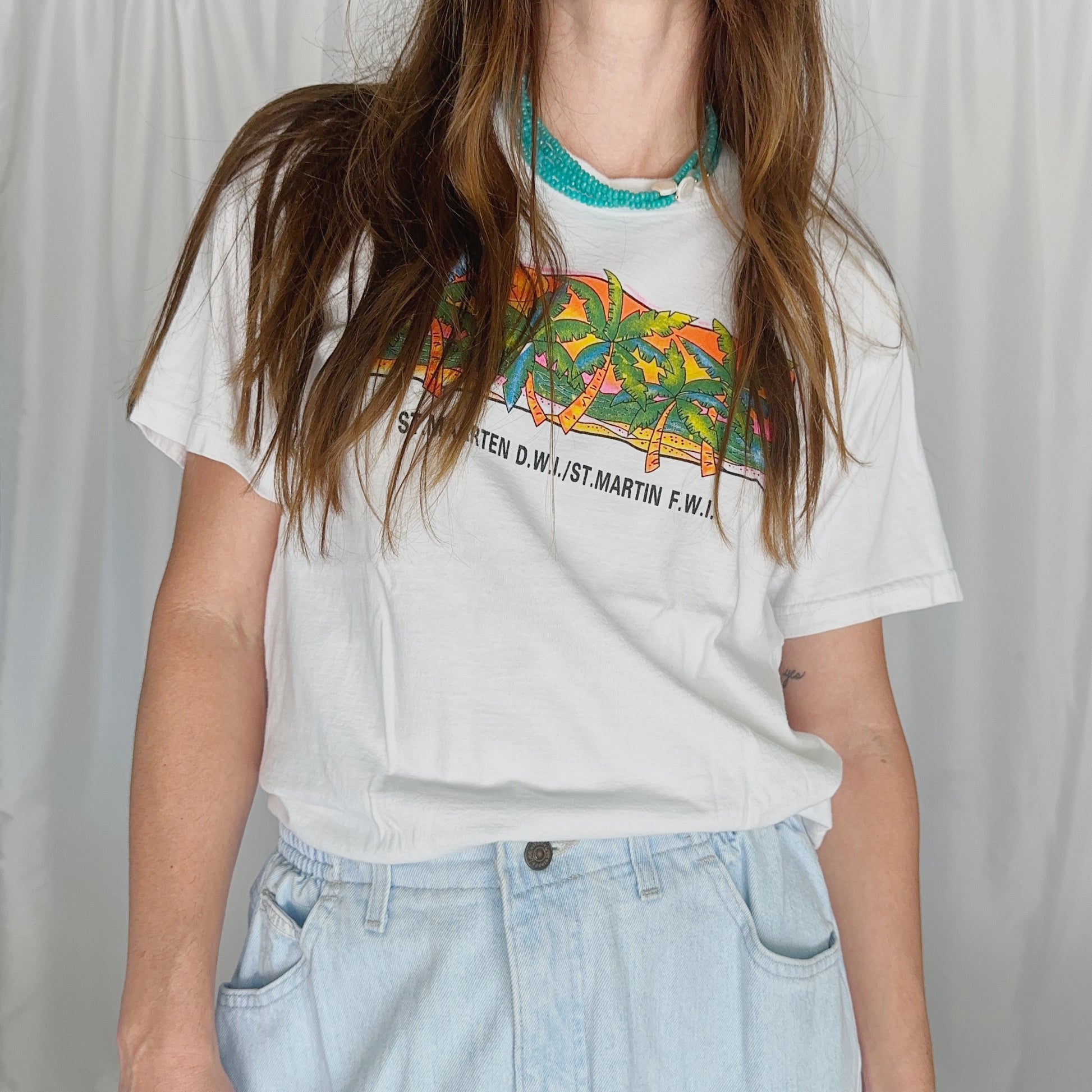 model wearing cheap vintage tshirt and jeans with beaded collar necklace