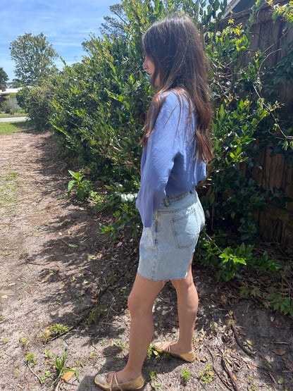 Girl standing in front of bush wearing vintage collared blouse for women.